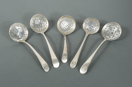 Lot 456 - A George II silver sugar sifting spoon together with four early George III silver examples