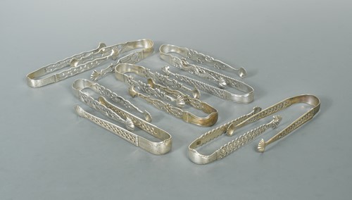 Lot 466 - Ten pairs of George III cast silver sugar tongs