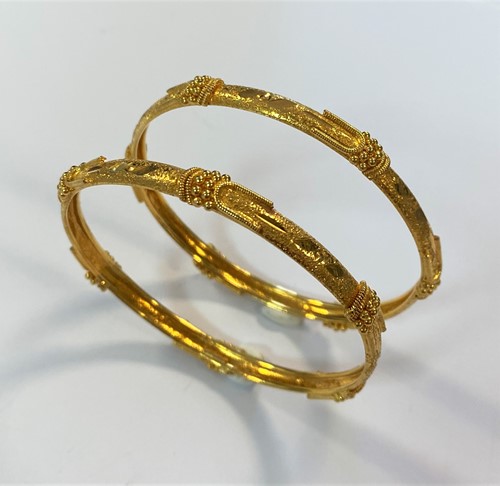 Lot 23 - A pair of Indian jali kada bangles