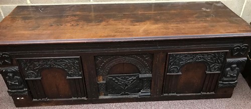 Lot 379 - A carved and moulded oak low cupboard with...