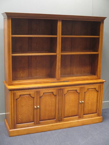 Lot 291 - A modern oak bookcase with open shelves above...