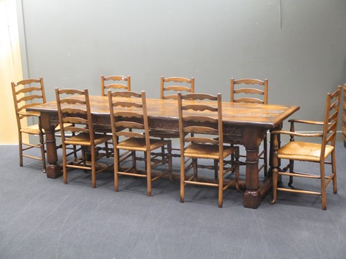 Lot 355 - A reproduction oak refectory table with carved...