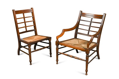 Lot 574 - An Aesthetic period walnut low elbow chair in the manner of Godwin