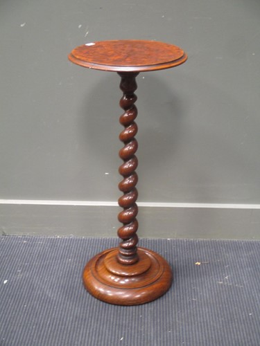 Lot 329 - A walnut candle stand raised on a barley twist...