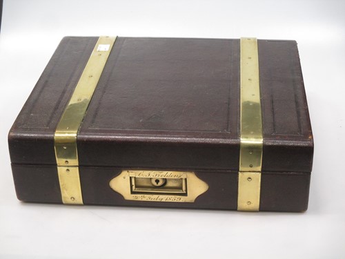 Lot 77 - A leather and brass bound desk box with key