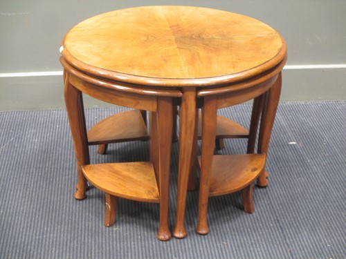 Lot 327 - A nest of walnut tables, largest 47cm high...