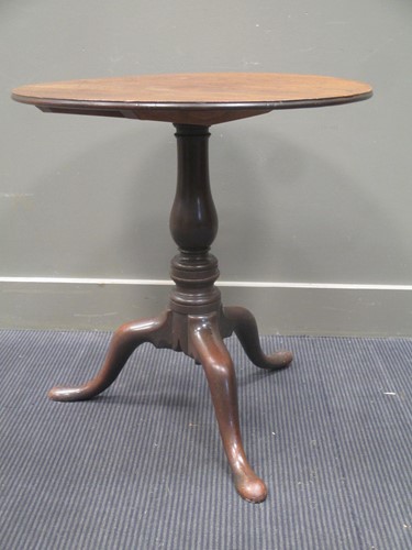 Lot 335 - A George III mahogany circular tip top table...