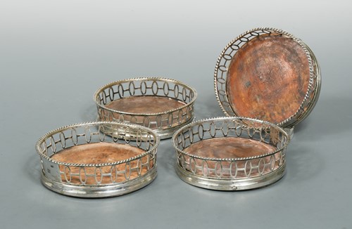 Lot 415 - Four probably late 18th Century German metalwares wine coasters