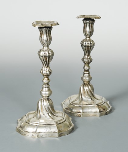 Lot 416 - A pair of German metalwares cast candlesticks, and another pair