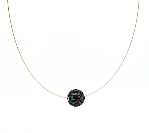 Lot 201 - A carved Tahitian cultured pearl pendant with turquoise bead interior and wire