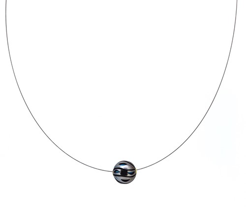 Lot 174 - A carved Tahitian cultured pearl pendant with turquoise bead interior and wire