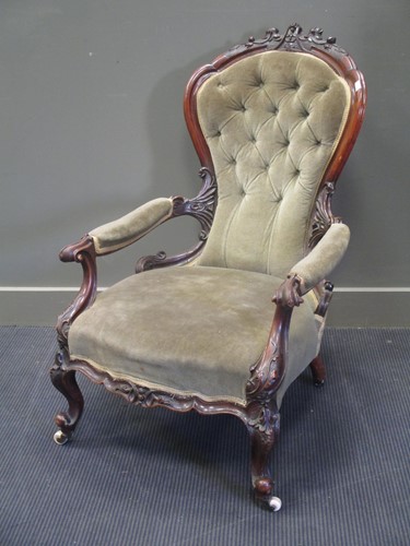 Lot 304 - A Victorian button upholstered open arm easy...
