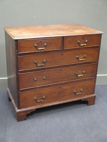 Lot 375 - A George III oak chest of drawers, with two...