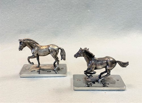 Lot 394 - A pair of 20th Century cast silver models of horses