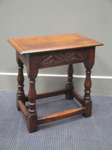 Lot 363 - A carved oak joint stool on baluster turned...