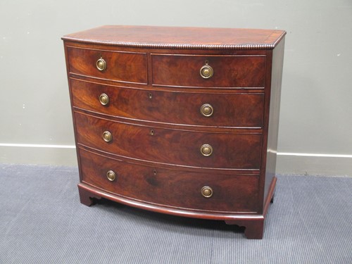 Lot 328 - A George III flame mahogany bow fronted chest...