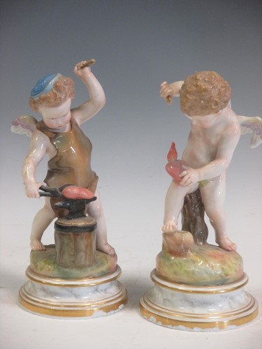Lot 62 - A pair of Meissen figures of cherubs, crossed...