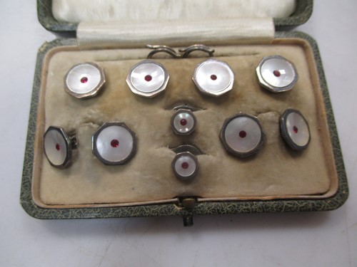 Lot 98 - A cased gentleman's dress set, stamped 'silver'...