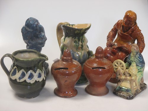 Lot 34 - Three glazed pottery seated figures, a Toby...