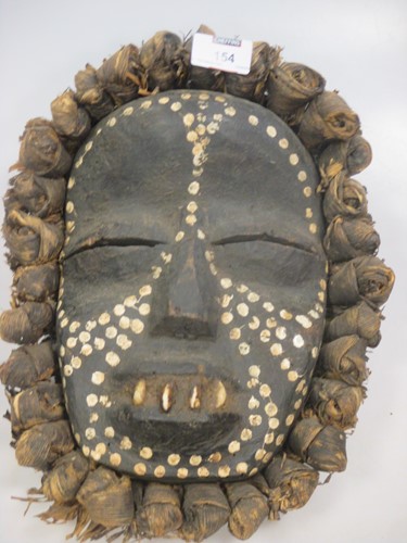 Lot 154 - A tribal mask with white dot paint decoration...