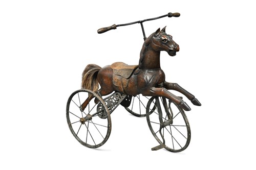 Lot 1005 - A carved wooden horse mounted as a tricycle, early 20th century
