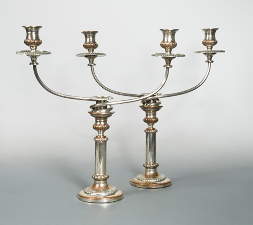 Lot 411 - A pair of silver plated on copper three light candelabra with telescopic columns