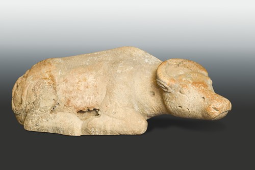 Lot 146 - A cream stone recumbent water buffalo, perhaps Tang Dynasty or earlier