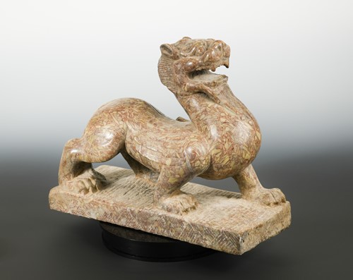Lot 150 - A red pudding stone carving of a Crouched Pixiu/Chimera, Northern Qi Dynasty style