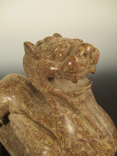 Lot 150 - A red pudding stone carving of a Crouched Pixiu/Chimera, Northern Qi Dynasty style