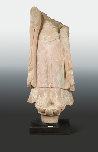 Lot 120 - A Chinese red sandstone lower enrobed torso of standing Buddha