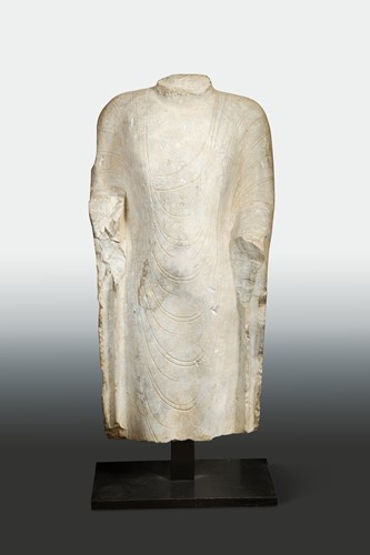 Lot 130 - A Chinese grey limestone torso of the enrobed Buddha, in Northern Qi Dynasty style