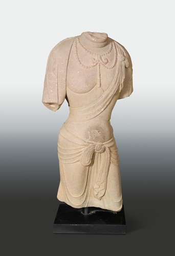 Lot 131 - A Chinese red sandstone torso of Avalokiteshvara, in Sui/Tang style