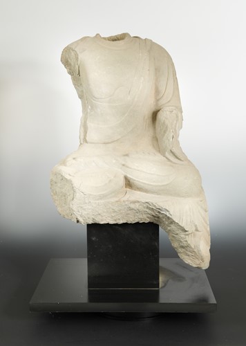 Lot 142 - A Chinese limestone seated Buddha, headless, perhaps Northern Wei Dynasty