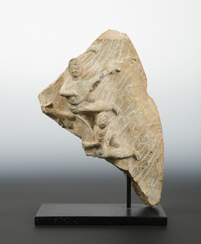 Lot 168 - A Chinese cream stone stele fragment with two apsara musicians, possibly Wei Dynasty