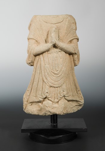 Lot 171 - A Chinese carved sandstone robed torso of a Buddhist deity, in Tang Dynasty style