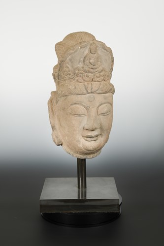 Lot 173 - A Chinese sandstone crowned head of Avalokiteshvara, in Tang Dynasty style
