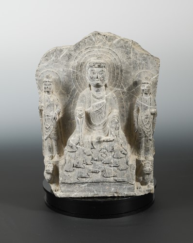 Lot 179 - A Chinese grey veined stone Buddhist triad group, also on reverse, in Eastern Wei style