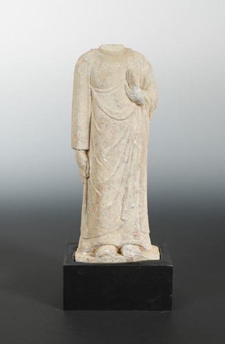 Lot 198 - A Chinese sandstone figure of an enrobed figure, headless, in early Tang style