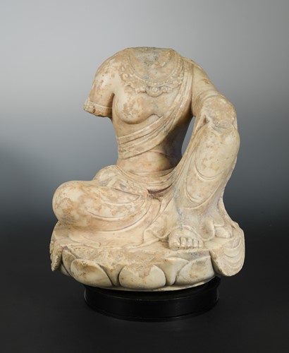 Lot 201 - A Chinese white marble figure of a seated Buddhist deity, headless, in early Sui Dynasty style
