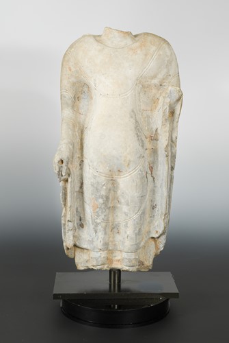 Lot 202 - A Chinese pale grey limestone fragmentary torso of a standing Buddha, in Qi Dynasty style