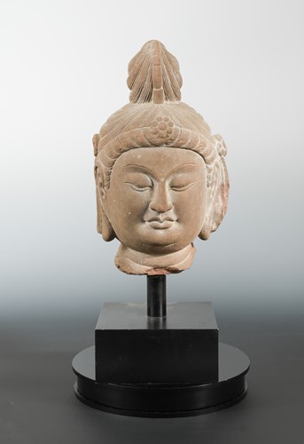 Lot 219 - A Chinese red sandstone carved head of Avalokiteshvara, in Song Dynasty style