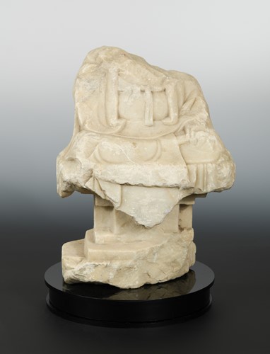 Lot 221 - A Chinese white marble fragmentary Buddhist deity on pedestal, in Northern Qi style