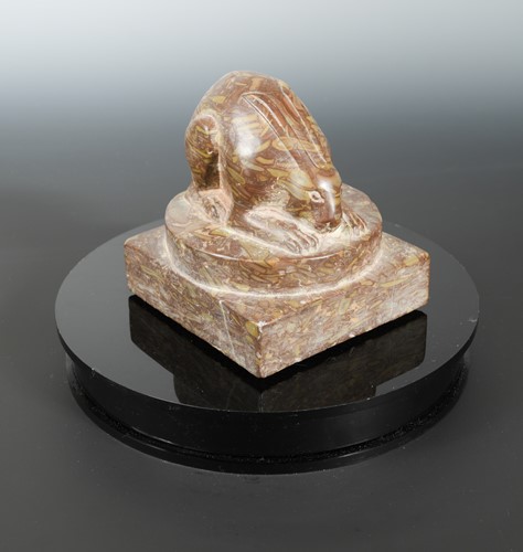 Lot 225 - A Chinese red puddingstone crouched hare, in Sui Dynasty style
