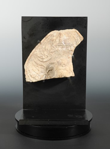 Lot 228 - A Chinese white marble aureole fragment with head of a Buddhist deity and apsara, perhaps Northern Qi Dynasty