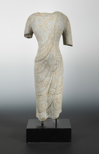 Lot 234 - A Chinese limestone fragmentary torso of a Buddha, in Wei Dynasty style