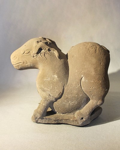 Lot 245 - A Chinese grey stone carving of a mythical animal, as a semi-recumbent deer, possibly Tang Dynasty