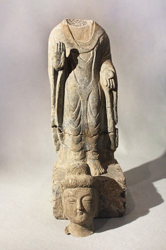 Lot 255 - A Chinese grey stone standing figure of a Buddha, in Wei Dynasty style