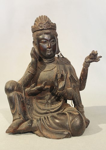 Lot 256 - A Chinese carved wood figure of the four-armed seated Bodhisattva Guanyin, 20th century