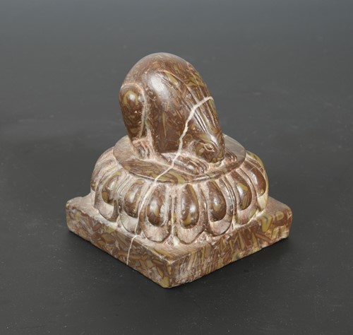 Lot 261 - A Chinese red puddingstone crouching hare