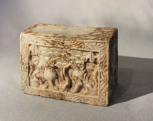 Lot 272 - A Chinese white marble pillow or stand in relief with mythical animals, in Wei Dynasty style